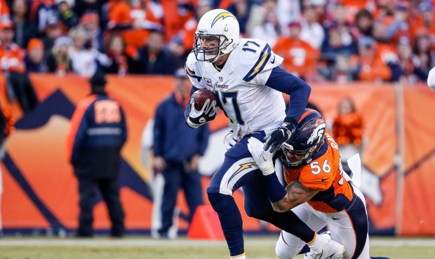 DENVER, CO - JANUARY 3:  Quarterback Philip Rivers #17 of the San Diego Chargers rushes and is hit ...