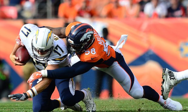 DENVER, CO - OCTOBER 30:  Quarterback Philip Rivers #17 of the San Diego Chargers is tackled by out...
