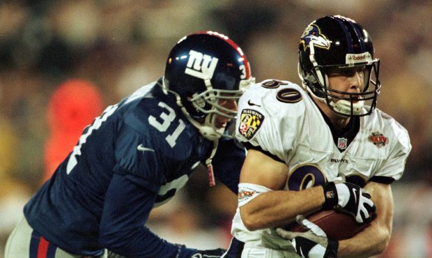 Brandon Stokley # 80 of the Baltimore Ravens makes a touch down catch with Jason Sehorn # 31 on his...