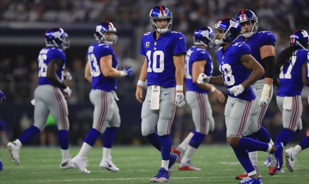 ARLINGTON, TX - SEPTEMBER 10:   Eli Manning #10 of the New York Giants walks off the field during p...