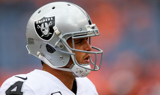 DENVER, CO - OCTOBER 1: Quarterback Derek Carr #4 of the Oakland Raiders stands on the field during...