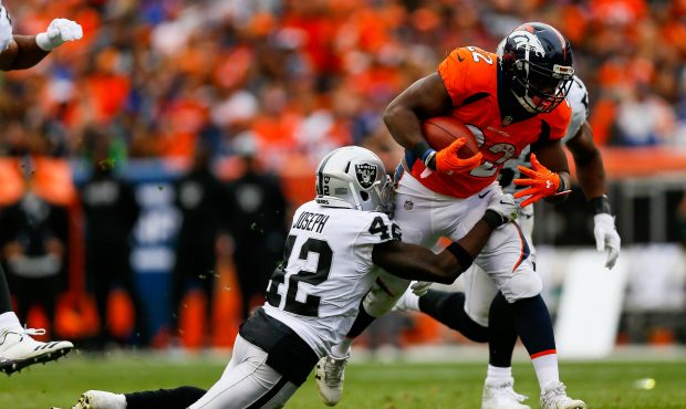 DENVER, CO - OCTOBER 1: Running back C.J. Anderson #22 of the Denver Broncos is hit by strong safet...