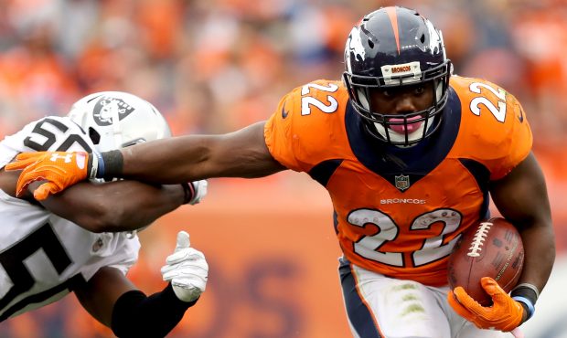 DENVER, CO - OCTOBER 01:  C.J. Anderson #22 of the Denver Broncos tries to break free from Nicholas...