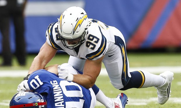 EAST RUTHERFORD, NJ - OCTOBER 08:  Joey Bosa #99 of the Los Angeles Chargers sacks Eli Manning #10 ...