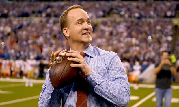 Peyton Manning steps back to throw a pass to former teammate Marvin Harrison during a presentation ...