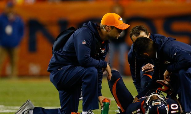 DENVER, CO - OCTOBER 15: Wide receiver Emmanuel Sanders #10 of the Denver Broncos is evaluated by t...