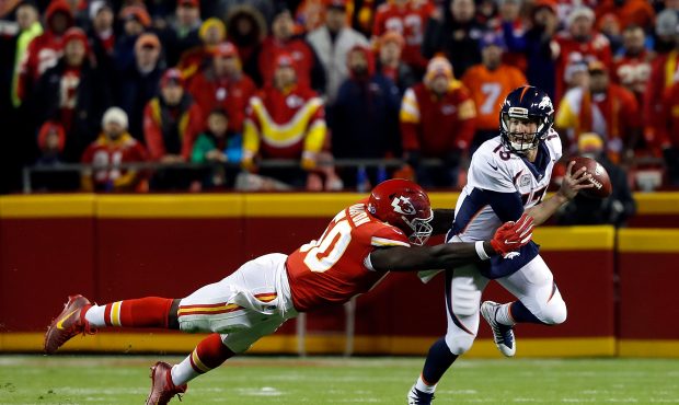 KANSAS CITY, MO - OCTOBER 30:  Quarterback Trevor Siemian #13 of the Denver Broncos is tackled by o...