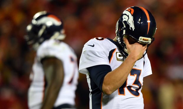 Quarterback Trevor Siemian #13 of the Denver Broncos walks off the field after throwing an intercep...