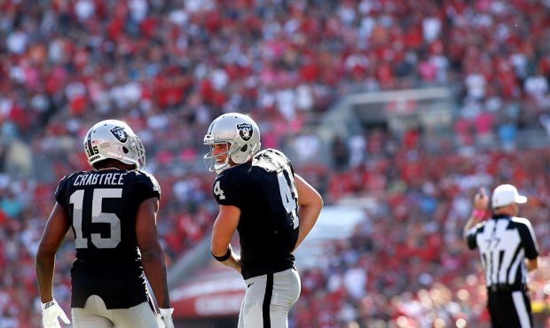 TAMPA, FL - OCTOBER 30:  Quarterback Derek Carr #4 of the Oakland Raiders talks to wide receiver Mi...