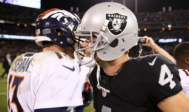 OAKLAND, CA - NOVEMBER 06:   Quarterbacks Derek Carr #4 of the Oakland Raiders and Trevor Siemian #...