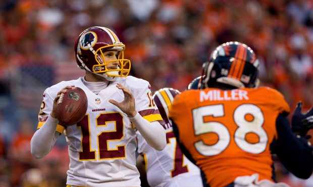 Quarterback Kirk Cousins #12 of the Washington Redskins looks to pass at Sports Authority Field Fie...