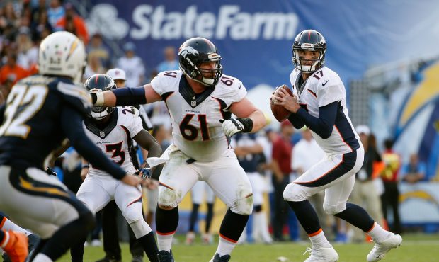 SAN DIEGO, CA - DECEMBER 06:   Matt Paradis #61 of the Denver Broncos blocks for  Brock Osweiler #1...