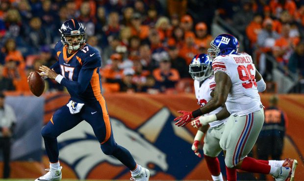 DENVER, CO - OCTOBER 15:  Quarterback Brock Osweiler #17 of the Denver Broncos moves out of the poc...