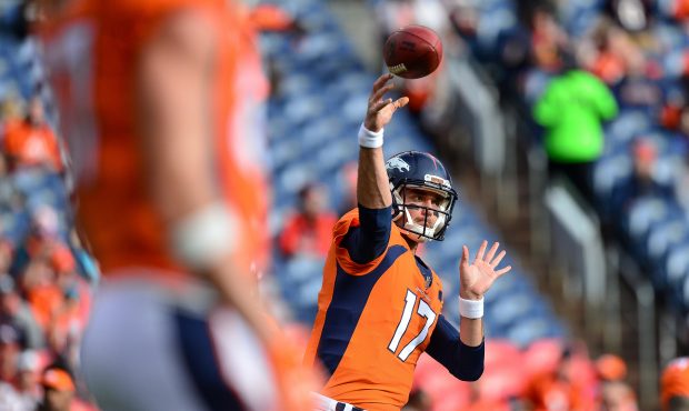 Quarterback Brock Osweiler #17 of the Denver Broncos throws as he warms up before a game against th...