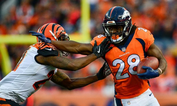 DENVER, CO - NOVEMBER 19: Running back Jamaal Charles #28 of the Denver Broncos gives a stiff arm t...