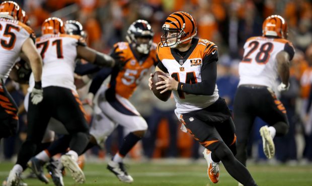DENVER, CO - NOVEMBER 19:  Andy Dalton #14 of the Cincinnati Bengals lrolls out of the pocket again...