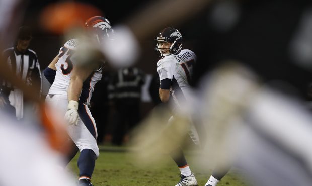 Quarterback Trevor Siemian #13 of the Denver Broncos looks to throw a pass during the fourth quarte...