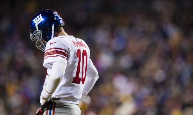 Quarterback Eli Manning #10 of the New York Giants reacts after a play in the fourth quarter agains...