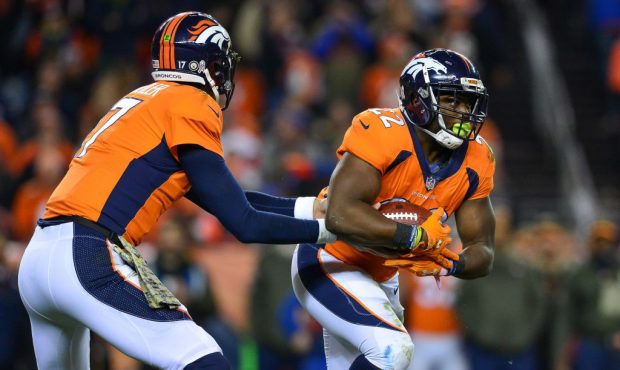 DENVER, CO - NOVEMBER 12:  Running back C.J. Anderson #22 of the Denver Broncos takes a handoff fro...
