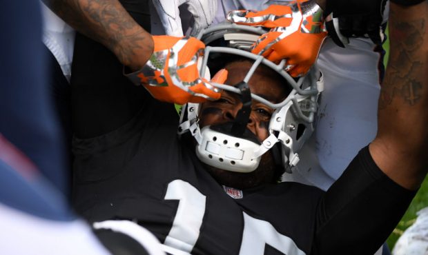OAKLAND, CA - NOVEMBER 26:  Michael Crabtree #15 of the Oakland Raiders has his helmet pulled off d...