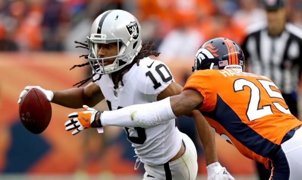 DENVER, CO - OCTOBER 01:  Seth Roberts #10  of the Oakland Raiders attempts to elude Chris Harris J...