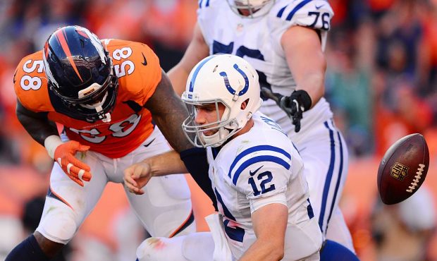 DENVER, CO - SEPTEMBER 18:  Outside linebacker Von Miller #58 of the Denver Broncos strips the ball...