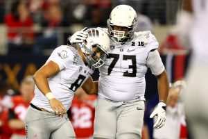 Quarterback Marcus Mariota #8 of the Oregon Ducks reacts to a play with teammate offensive lineman Tyrell Crosby #73 against the Ohio State Buckeyes during the College Football Playoff National Championship Game at AT&T Stadium on January 12, 2015 in Arlington, Texas. (Photo by Ronald Martinez/Getty Images)