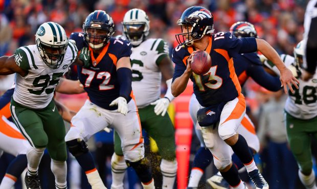 Quarterback Trevor Siemian #13 of the Denver Broncos scrambles as the pocket breaks down in the thi...