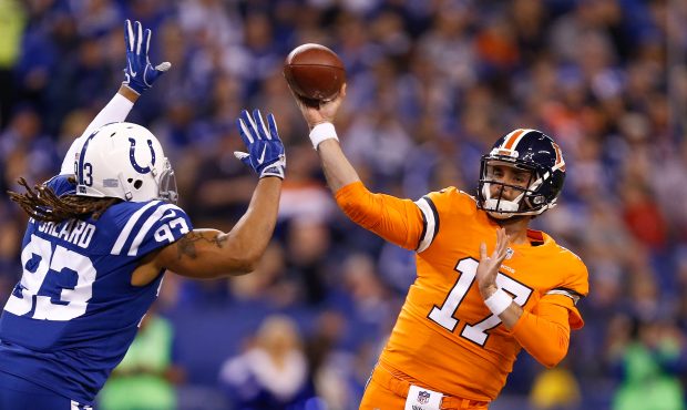 Brock Osweiler #17 of the Denver Broncos throws a pass under pressure from Jabaal Sheard #93 of the...
