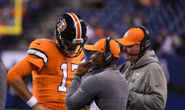 Denver Broncos quarterback Brock Osweiler (17) talks with offensive coordinator Bill Musgrave and h...
