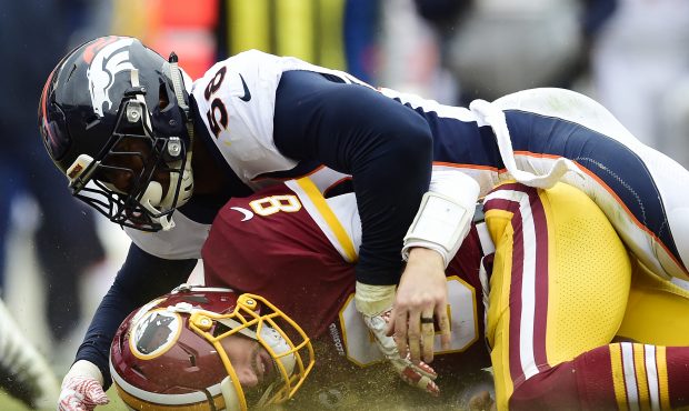 Quarterback Kirk Cousins #8 of the Washington Redskins is sacked by outside linebacker Von Miller #...