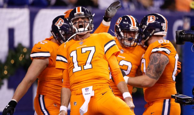 Brock Osweiler #17 of the Denver Broncos celebrates with teammates after a touchdown against the In...