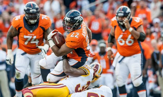 DENVER, CO - OCTOBER 27:  Running Back C.J. Anderson #22 of the Denver Broncos is tackled by defens...