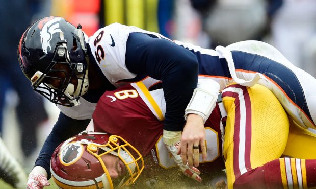 LANDOVER, MD - DECEMBER 24: Quarterback Kirk Cousins #8 of the Washington Redskins is sacked by out...
