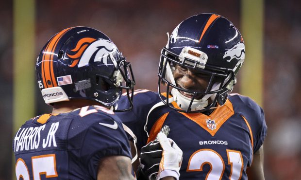 Denver Broncos starting cornerback duo Chris Harris Jr. #25 and Aqib Talib #21 celebrate a defensiv...