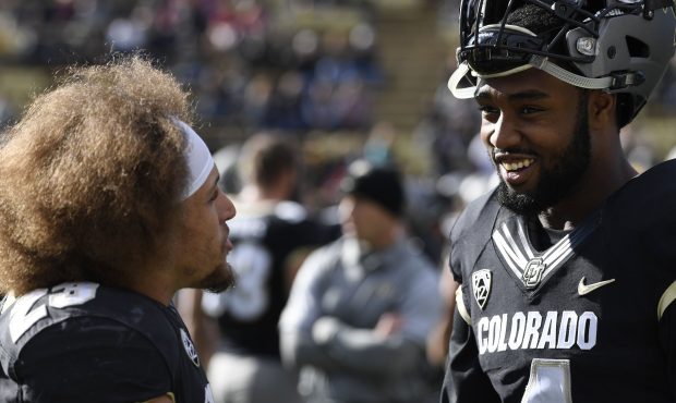 Colorado Buffaloes running back Phillip Lindsay #23 and Colorado wide receiver Bryce Bobo #4 talk d...