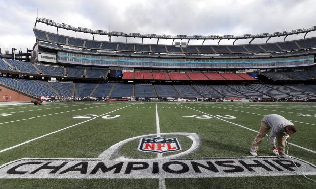 Fred Fletcher, field superintendent, applies the finishing touches to the logo at Gillette Stadium ...