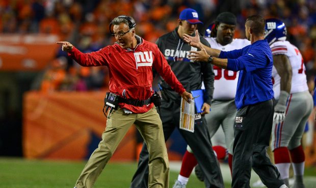 Offensive Coordinator Mike Sullivan celebrates after a second quarter score against the Denver Bron...