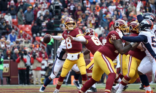 LANDOVER, MD - DECEMBER 24: Quarterback Kirk Cousins #8 of the Washington Redskins throws a first h...
