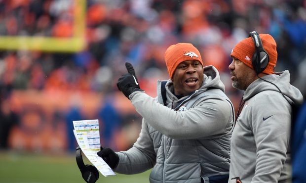 Denver Broncos head coach Vance Joseph screams as running backs coach Eric Studesville listens in d...