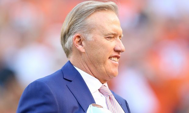 DENVER, CO - SEPTEMBER 08:  General Manager John Elway holds the Lombardi Trophy to celebrate the D...