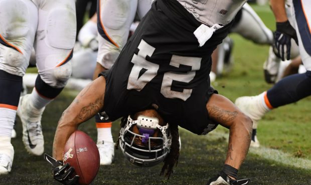 OAKLAND, CA - NOVEMBER 26:  Marshawn Lynch #24 of the Oakland Raiders dives into the end zone for a...