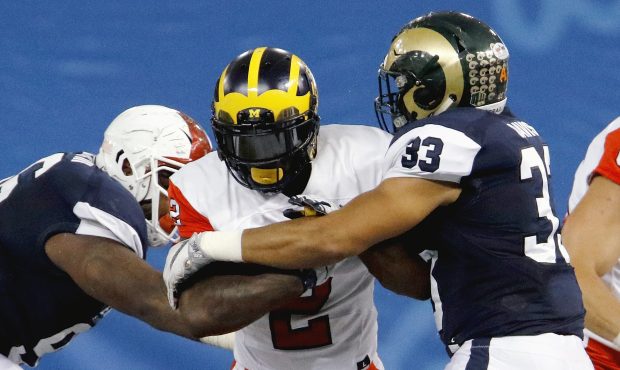 ST. PETERSBURG, FL - JANUARY 21:  East's De'Veon Smith #2 of Michigan fights his way through the ar...