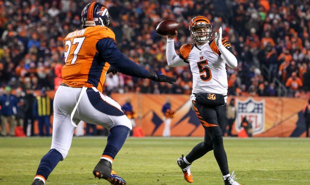 Quarterback AJ McCarron #5 of the Cincinnati Bengals throws as he is pressured by defensive end Mal...