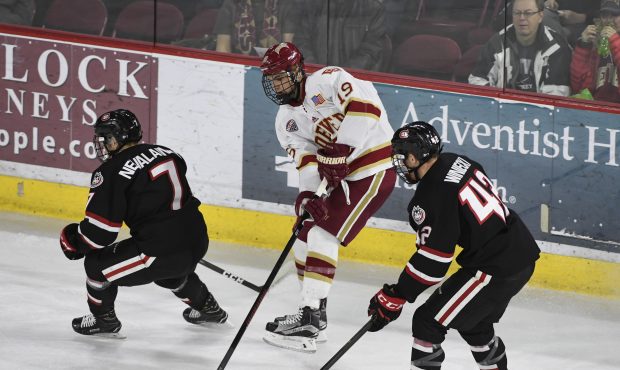 Denver Pioneers forward Troy Terry (19) goes after the puck in between St. Cloud State Huskies defe...