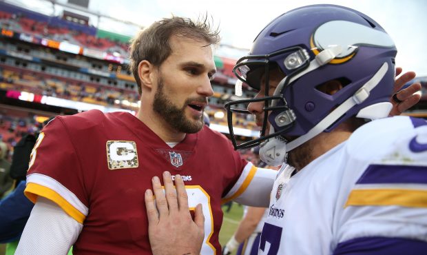 Quarterback Kirk Cousins #8 of the Washington Redskins talks with quarterback Case Keenum #7 of the...