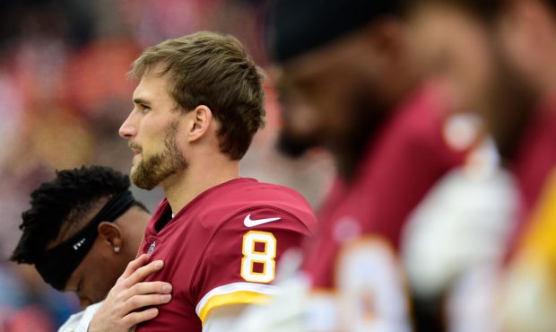 LANDOVER, MD - DECEMBER 24: Quarterback Kirk Cousins #8 of the Washington Redskins listens to the N...