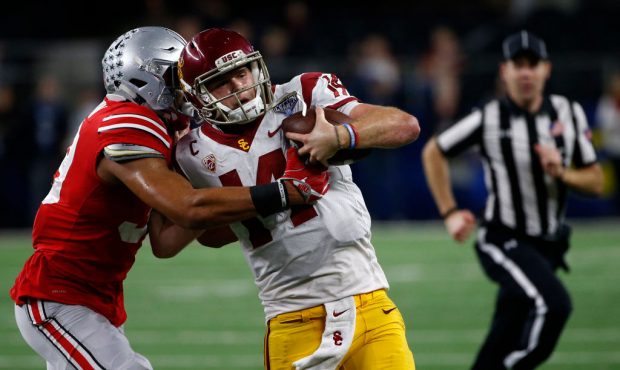 ARLINGTON, TX - DECEMBER 29: Malik Harrison #39 of the Ohio State Buckeyes runs Sam Darnold #14 of ...