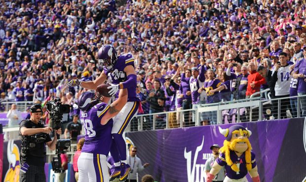 MINNEAPOLIS, MN - OCTOBER 9:  Jeremiah Sirles #78 lifts Adam Thielen #19 of the Minnesota Vikings i...