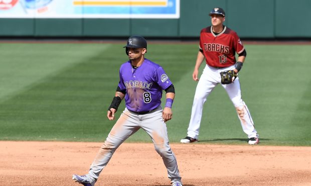 Gerardo Parra #8 of the Colorado Rockies takes a lead from second base as Nick Ahmed #13 of the Ari...